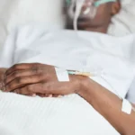 sick-african-american-man-hospital-close-up-unrecognizable-african-american-man-lying-white-hospital-bed-focus-iv-215244787